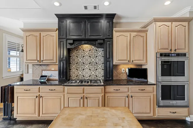 a kitchen with stainless steel appliances white cabinets and a sink