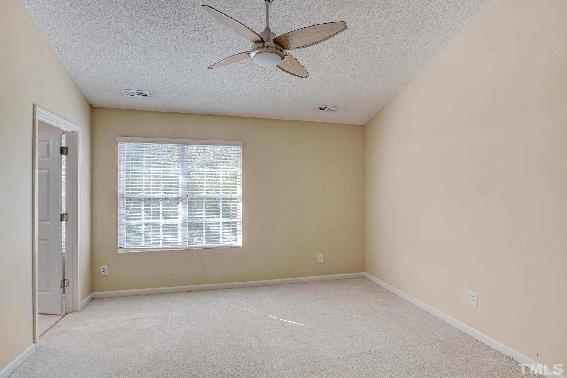 508 Erie Road Raleigh, NC 27610 - Photo 21 of 33 an empty room with a window and ceiling fan