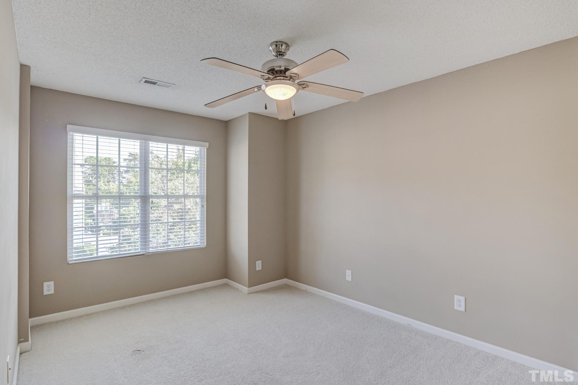 508 Erie Road Raleigh, NC 27610 - Photo 24 of 33 an empty room with a window and a fan