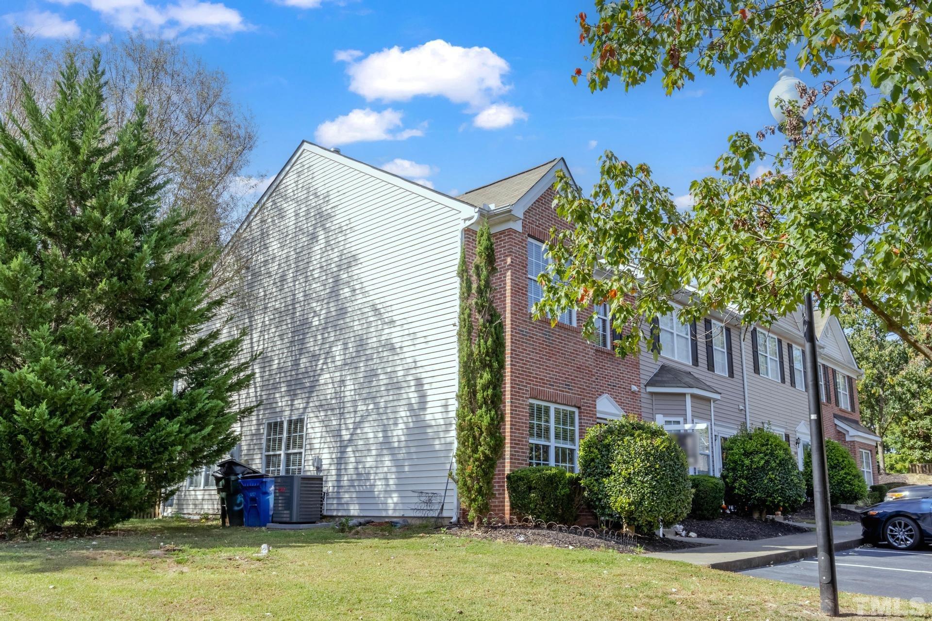508 Erie Road Raleigh, NC 27610 - Photo 5 of 33 a tall building with trees in front of it