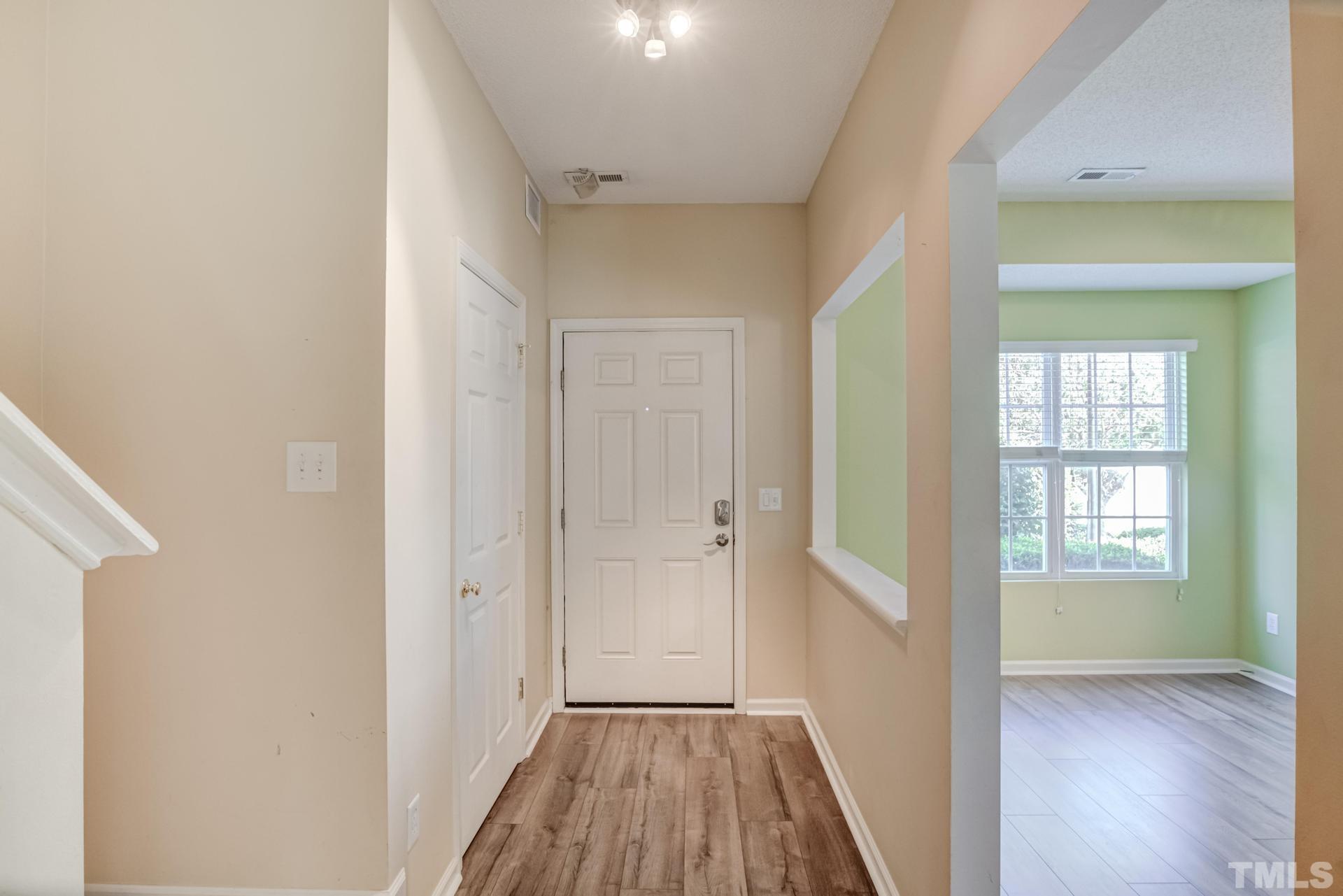508 Erie Road Raleigh, NC 27610 - Photo 7 of 33 a view of a room with wooden floor closet and windows