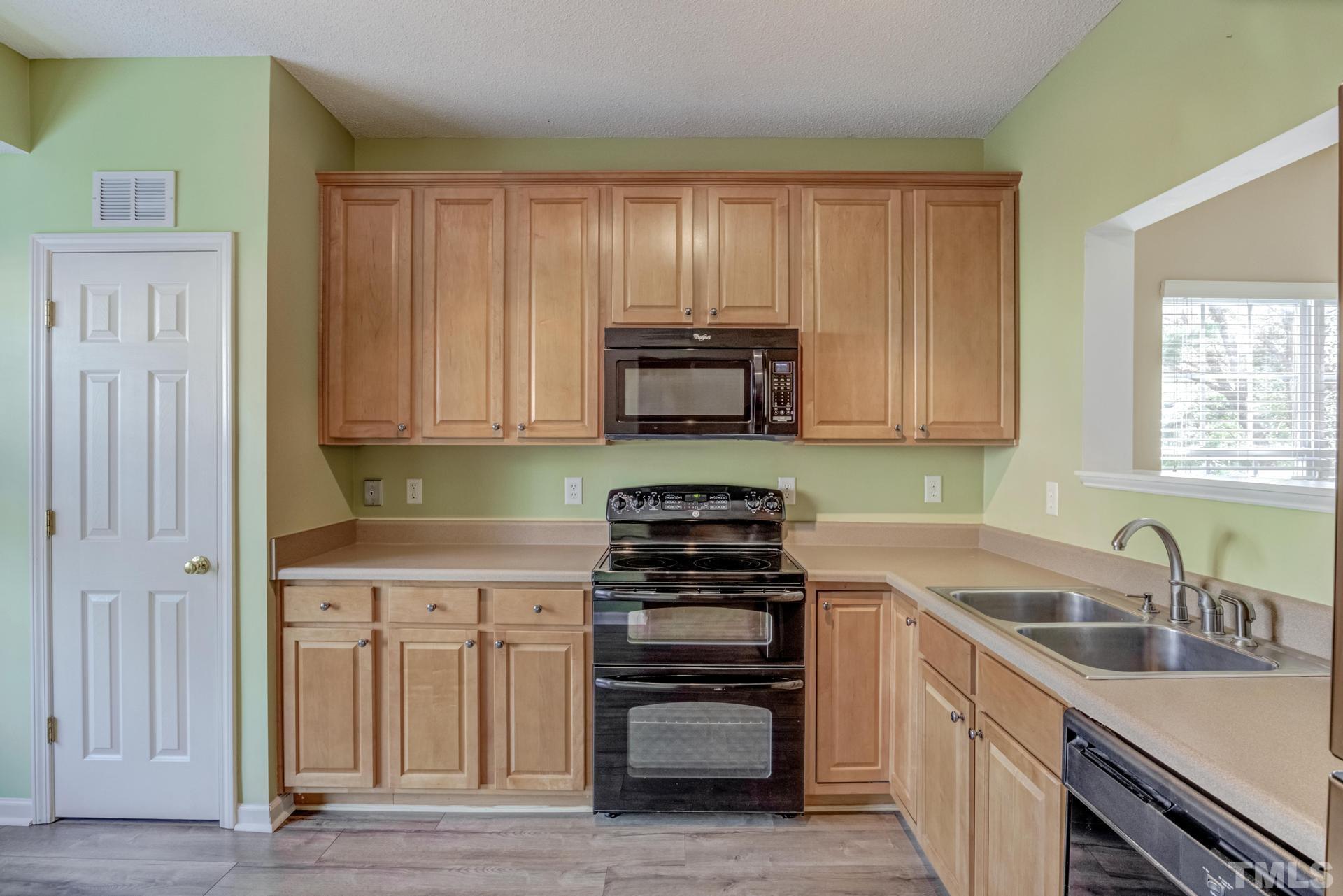 508 Erie Road Raleigh, NC 27610 - Photo 8 of 33 a kitchen with granite countertop a stove and a sink