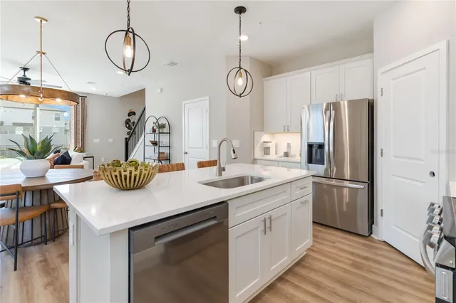 a kitchen with a sink cabinets and stainless steel appliances