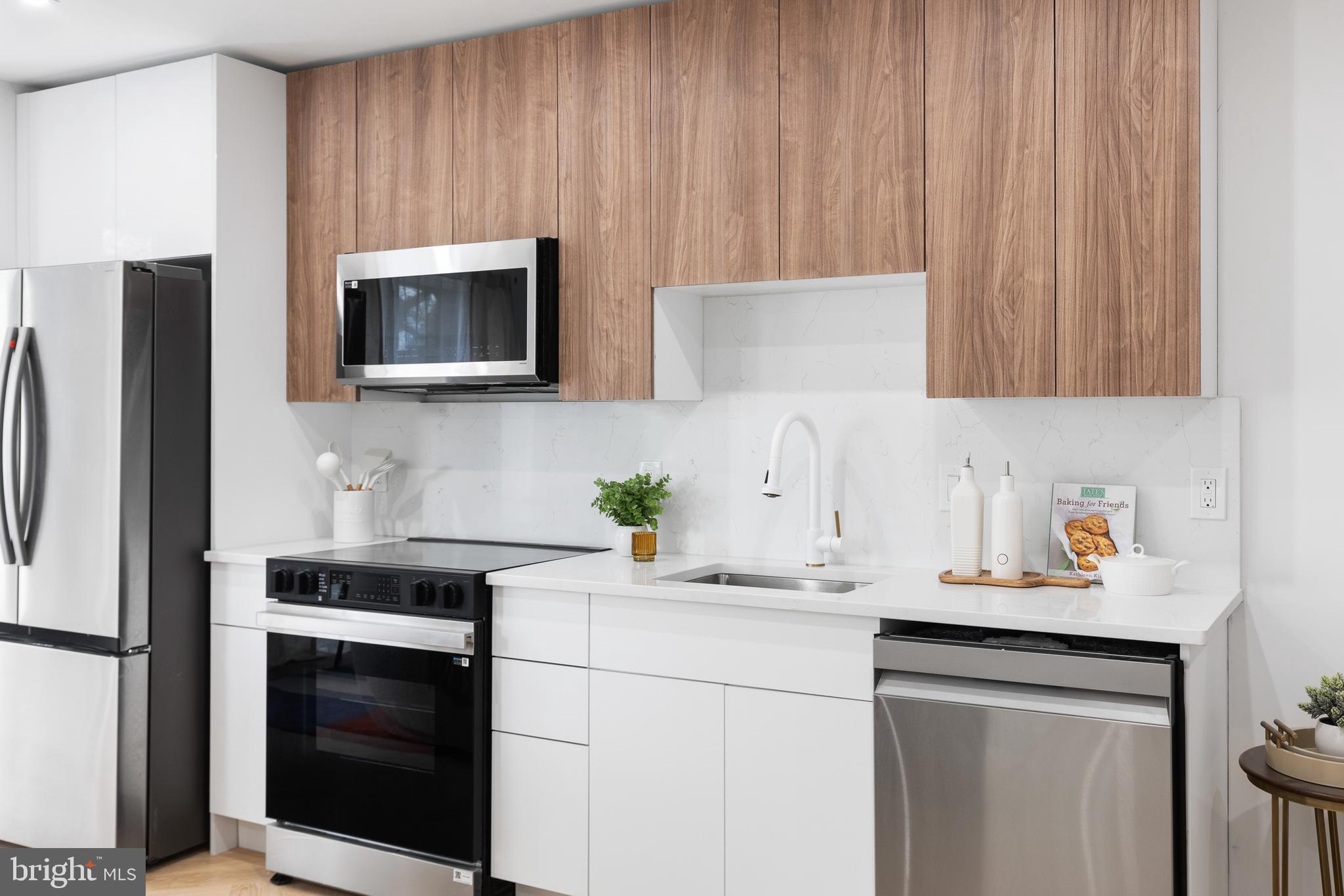1124 Florida Street Northeast, Unit 203 Washington, DC 20002 - Photo 13 of 18 a kitchen with stainless steel appliances a stove microwave and sink