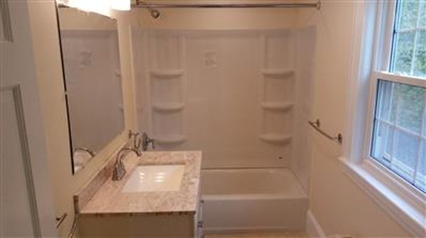 75 Great Road Maynard, MA 01754 - Photo 7 of 11 a bathroom with a sink a bathtub and shower