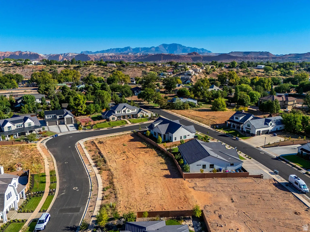 1240 North Gallen Road, Unit 12 Santa Clara, UT 84765 - Photo 12 of 19 Expansive undeveloped lot featuring clear terrain, paved road access, and mountainous scenery