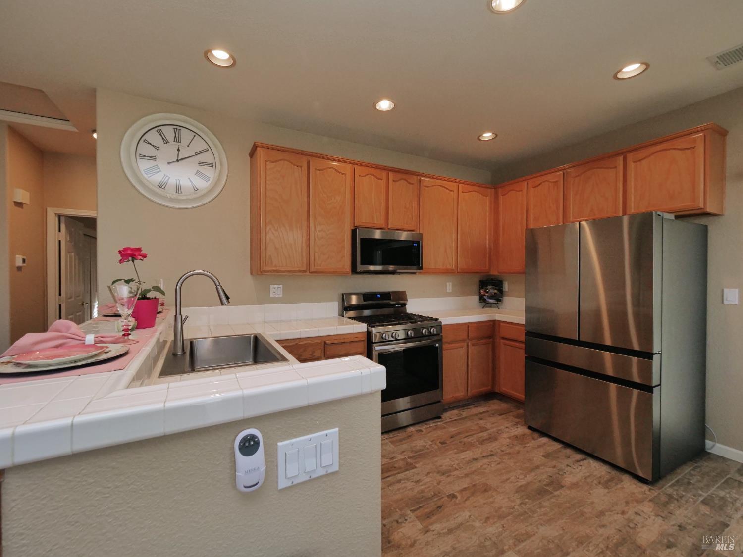 773 Turnberry Terrace Rio Vista, CA 94571 - Photo 12 of 52 a kitchen with granite countertop stainless steel appliances a refrigerator a stove a sink and a refrigerator with wooden floor