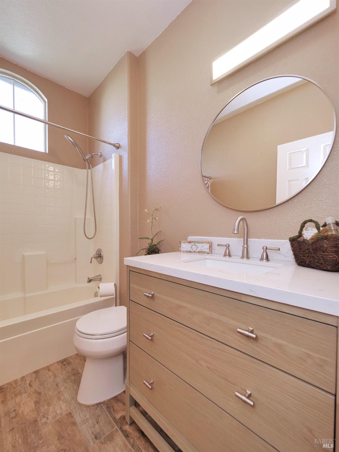 773 Turnberry Terrace Rio Vista, CA 94571 - Photo 17 of 52 a bathroom with a granite countertop toilet sink and mirror