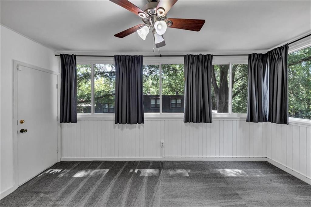 144 Woodmere Square Northwest Atlanta, GA 30327 - Photo 12 of 43 a view of an empty room with wooden floor and a window