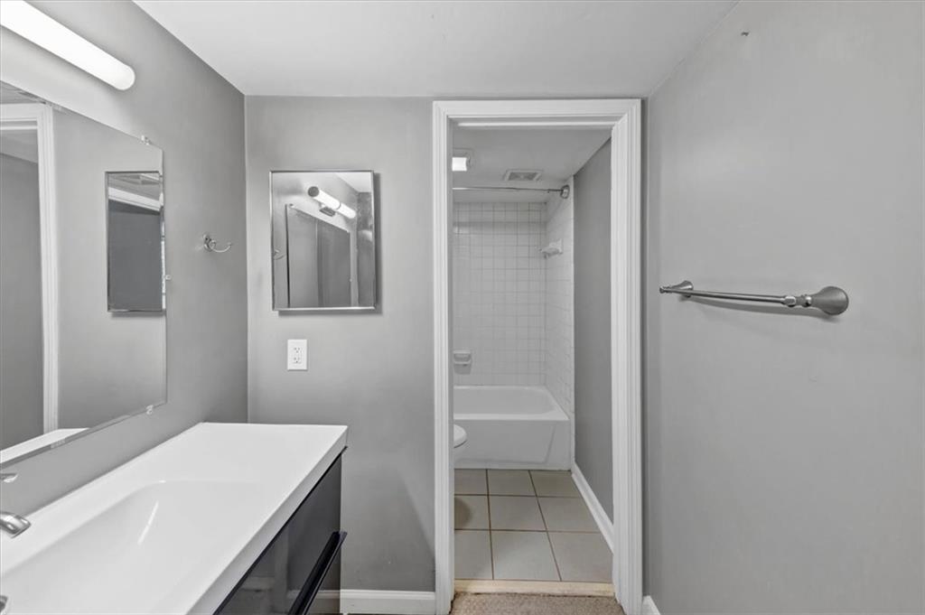 144 Woodmere Square Northwest Atlanta, GA 30327 - Photo 19 of 43 a bathroom with a sink and a mirror