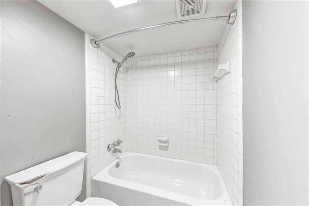 144 Woodmere Square Northwest Atlanta, GA 30327 - Photo 20 of 43 a bathroom with a bathtub and a shower