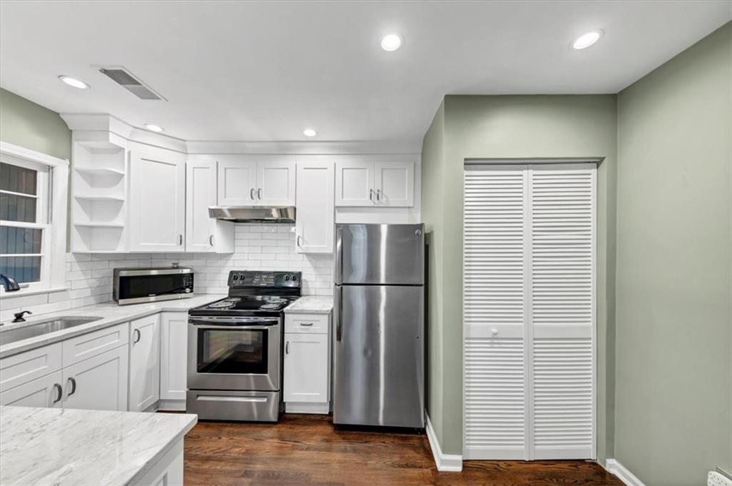 144 Woodmere Square Northwest Atlanta, GA 30327 - Photo 2 of 43 a kitchen with a sink stainless steel appliances and cabinets