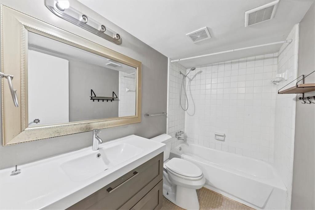 144 Woodmere Square Northwest Atlanta, GA 30327 - Photo 23 of 43 a bathroom with a double vanity sink toilet mirror and bathtub