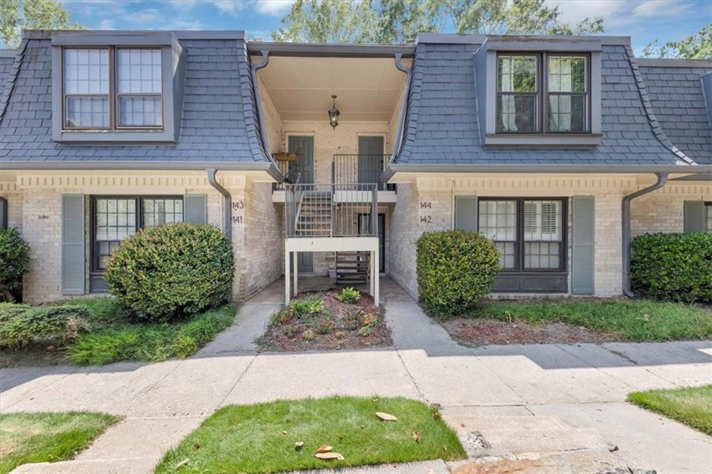 144 Woodmere Square Northwest Atlanta, GA 30327 - Photo 24 of 43 a front view of a house with garden