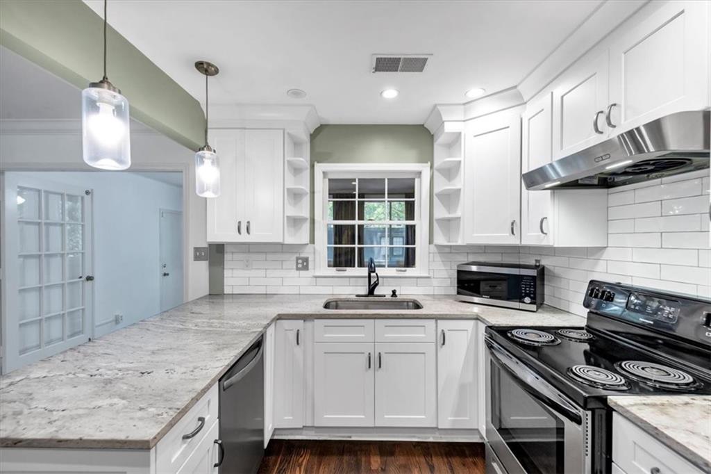 144 Woodmere Square Northwest Atlanta, GA 30327 - Photo 3 of 43 a kitchen with granite countertop a stove sink and cabinets