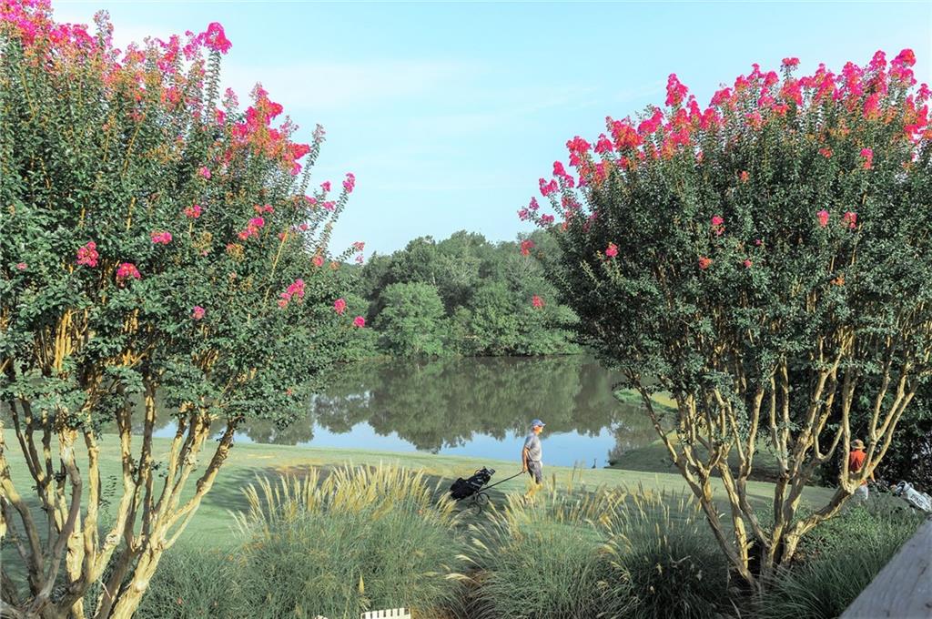 144 Woodmere Square Northwest Atlanta, GA 30327 - Photo 32 of 43 a front view of a house with a yard and fountain