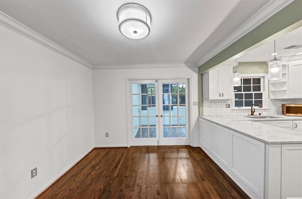 144 Woodmere Square Northwest Atlanta, GA 30327 - Photo 5 of 43 a view of a kitchen with wooden floor and a sink