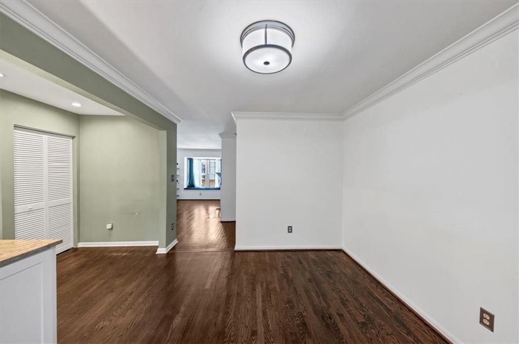 144 Woodmere Square Northwest Atlanta, GA 30327 - Photo 6 of 43 a view of empty room with wooden floor and fan