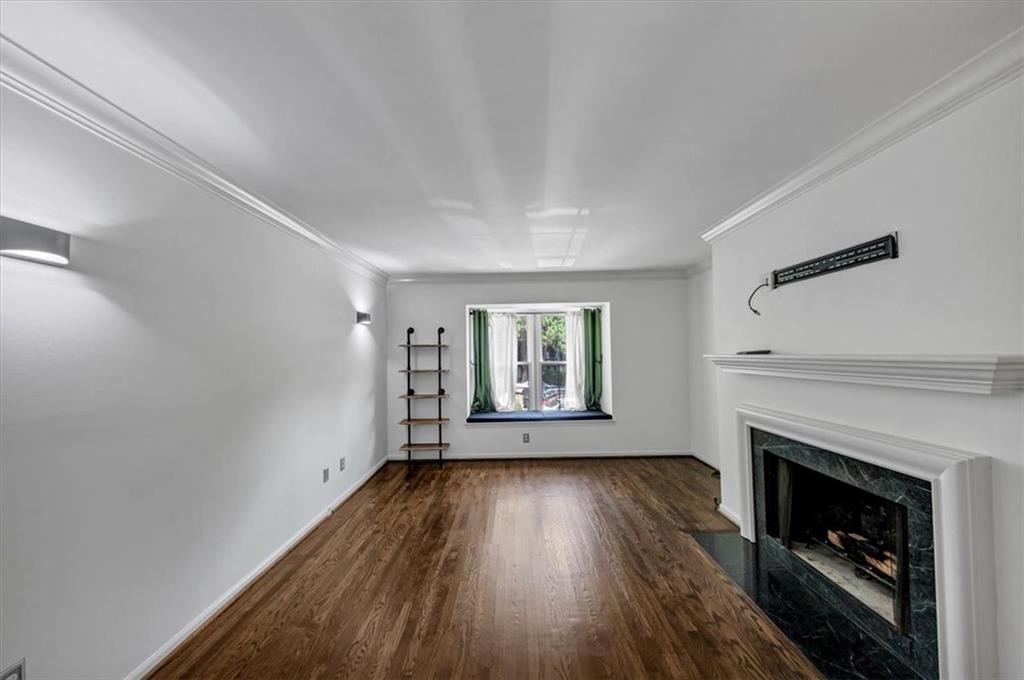 144 Woodmere Square Northwest Atlanta, GA 30327 - Photo 8 of 43 a view of empty room with a fireplace and wooden floor