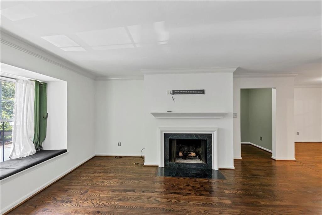 144 Woodmere Square Northwest Atlanta, GA 30327 - Photo 9 of 43 a view of an empty room with wooden floor fireplace and a window