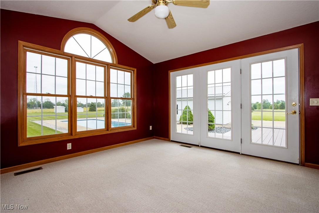 1500 Bell Road Wooster, OH 44691 - Photo 13 of 33 Spare room with vaulted ceiling, light colored carpet, baseboards, and ceiling fan