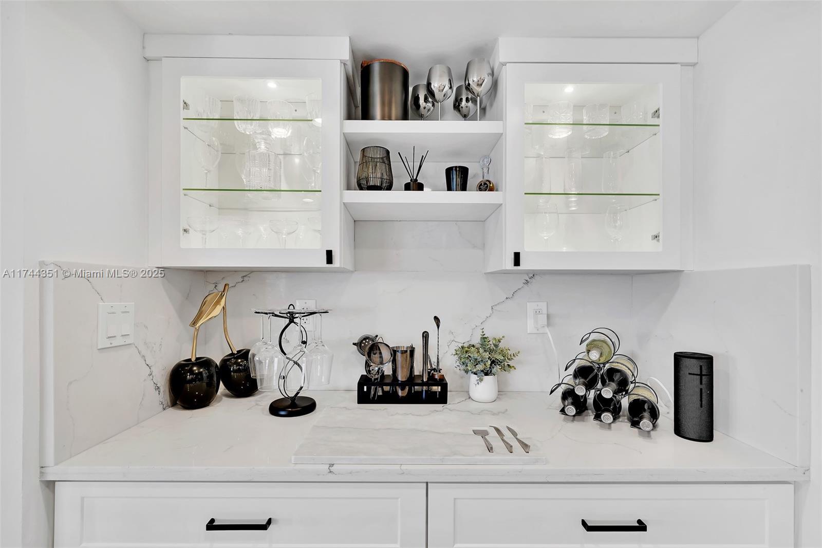 1012 North Ocean Boulevard, Unit 701 Pompano Beach, FL 33062 - Photo 13 of 57 a kitchen with white cabinets and white appliances