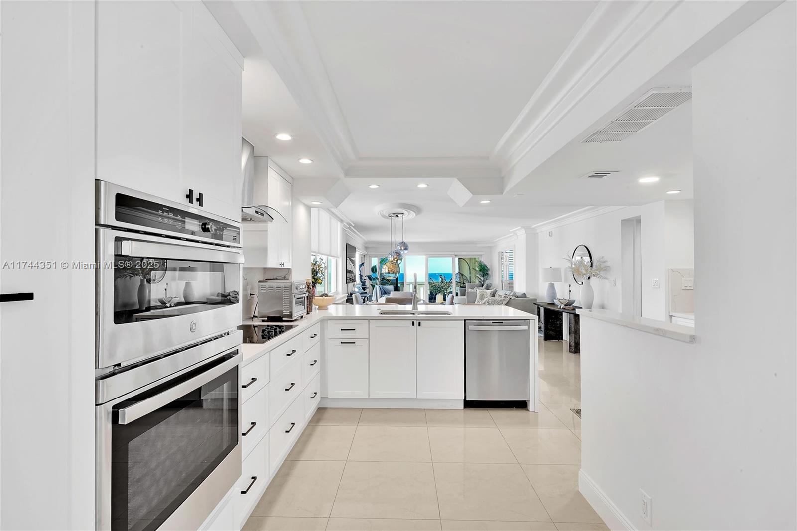 1012 North Ocean Boulevard, Unit 701 Pompano Beach, FL 33062 - Photo 17 of 57 a kitchen with a sink stainless steel appliances and cabinets
