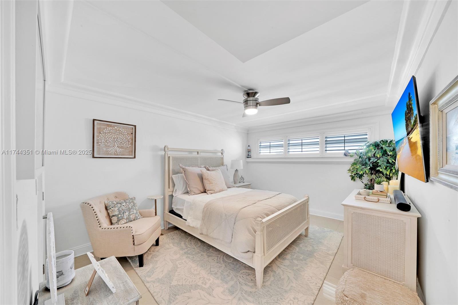 1012 North Ocean Boulevard, Unit 701 Pompano Beach, FL 33062 - Photo 19 of 57 a bedroom with a bed and a couch