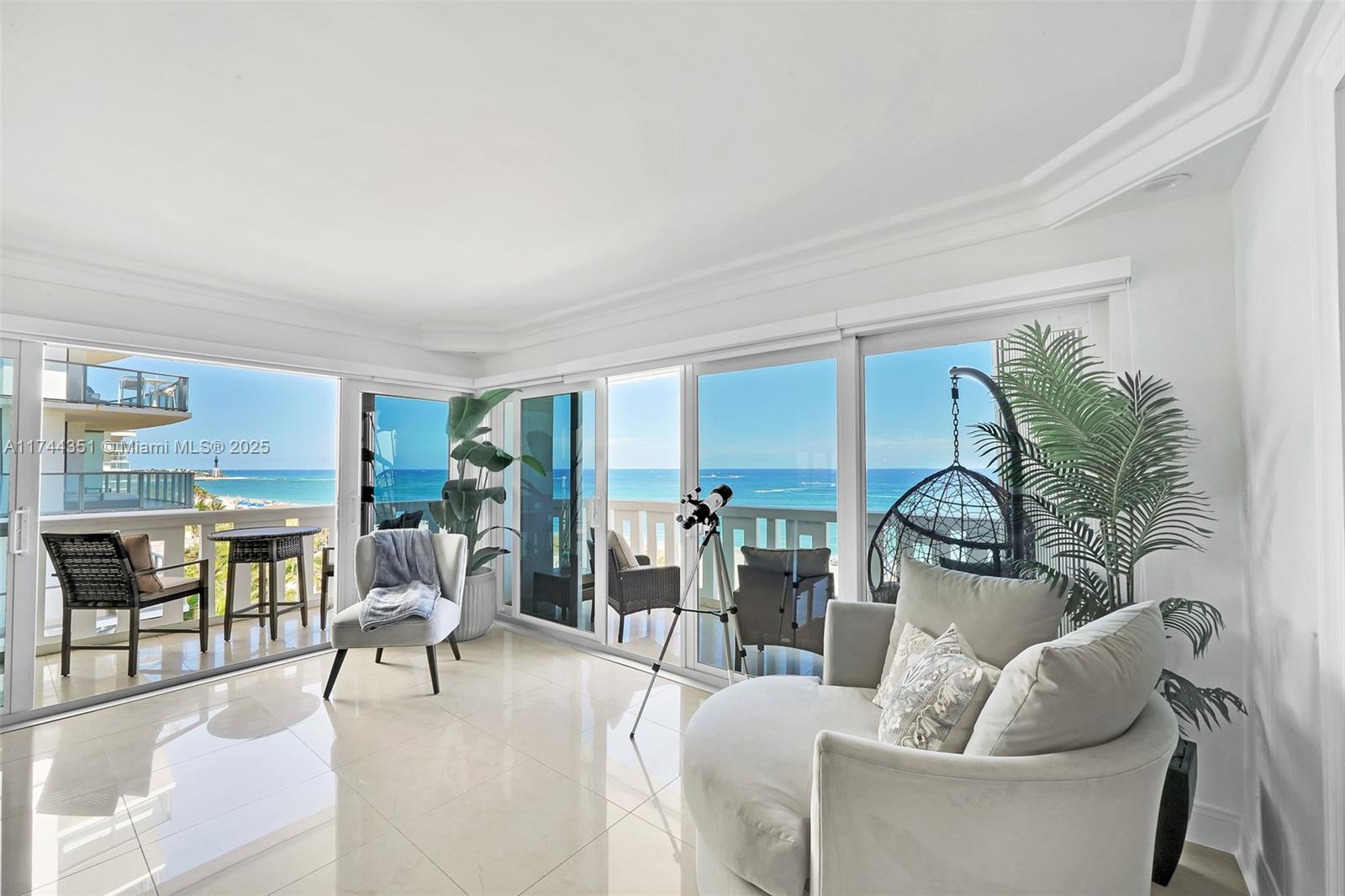 1012 North Ocean Boulevard, Unit 701 Pompano Beach, FL 33062 - Photo 2 of 57 a living room with furniture and a large window