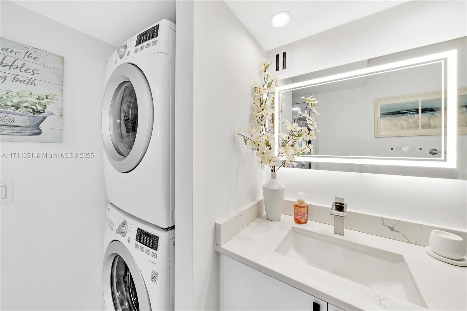 1012 North Ocean Boulevard, Unit 701 Pompano Beach, FL 33062 - Photo 23 of 57 a utility room with sink dryer and washer