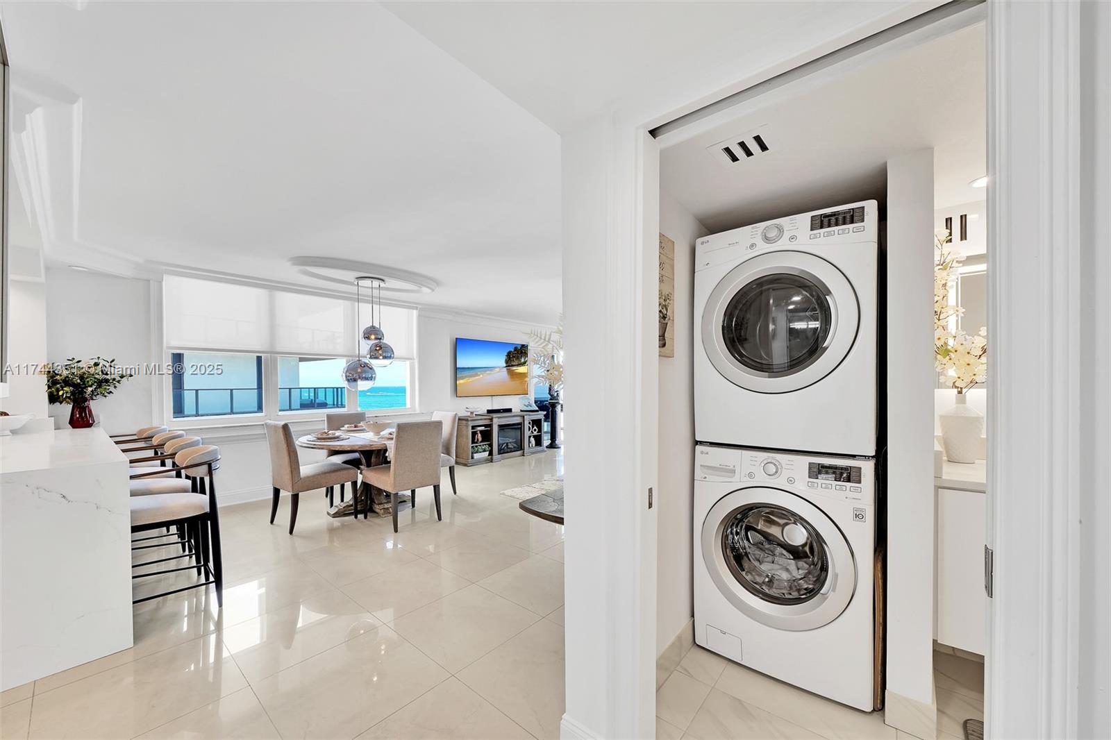 1012 North Ocean Boulevard, Unit 701 Pompano Beach, FL 33062 - Photo 24 of 57 a view of a living room with washer and dryer