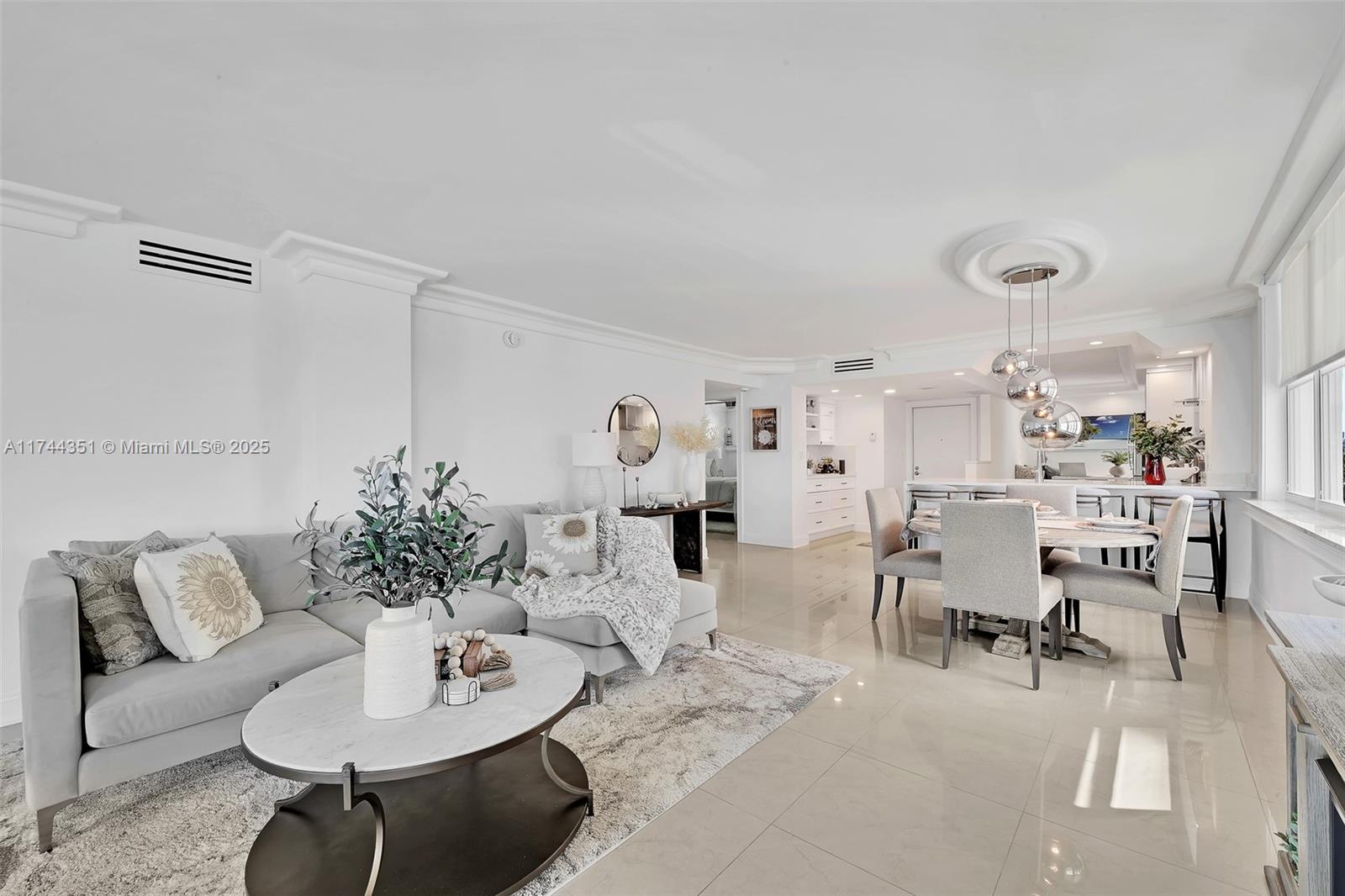 1012 North Ocean Boulevard, Unit 701 Pompano Beach, FL 33062 - Photo 26 of 57 a living room with furniture kitchen view and a table