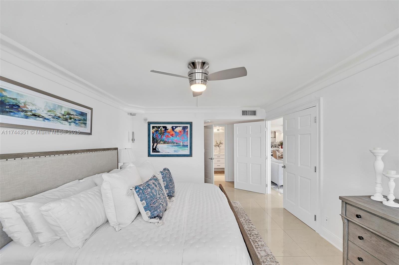 1012 North Ocean Boulevard, Unit 701 Pompano Beach, FL 33062 - Photo 28 of 57 a bed room with a bed and a ceiling fan