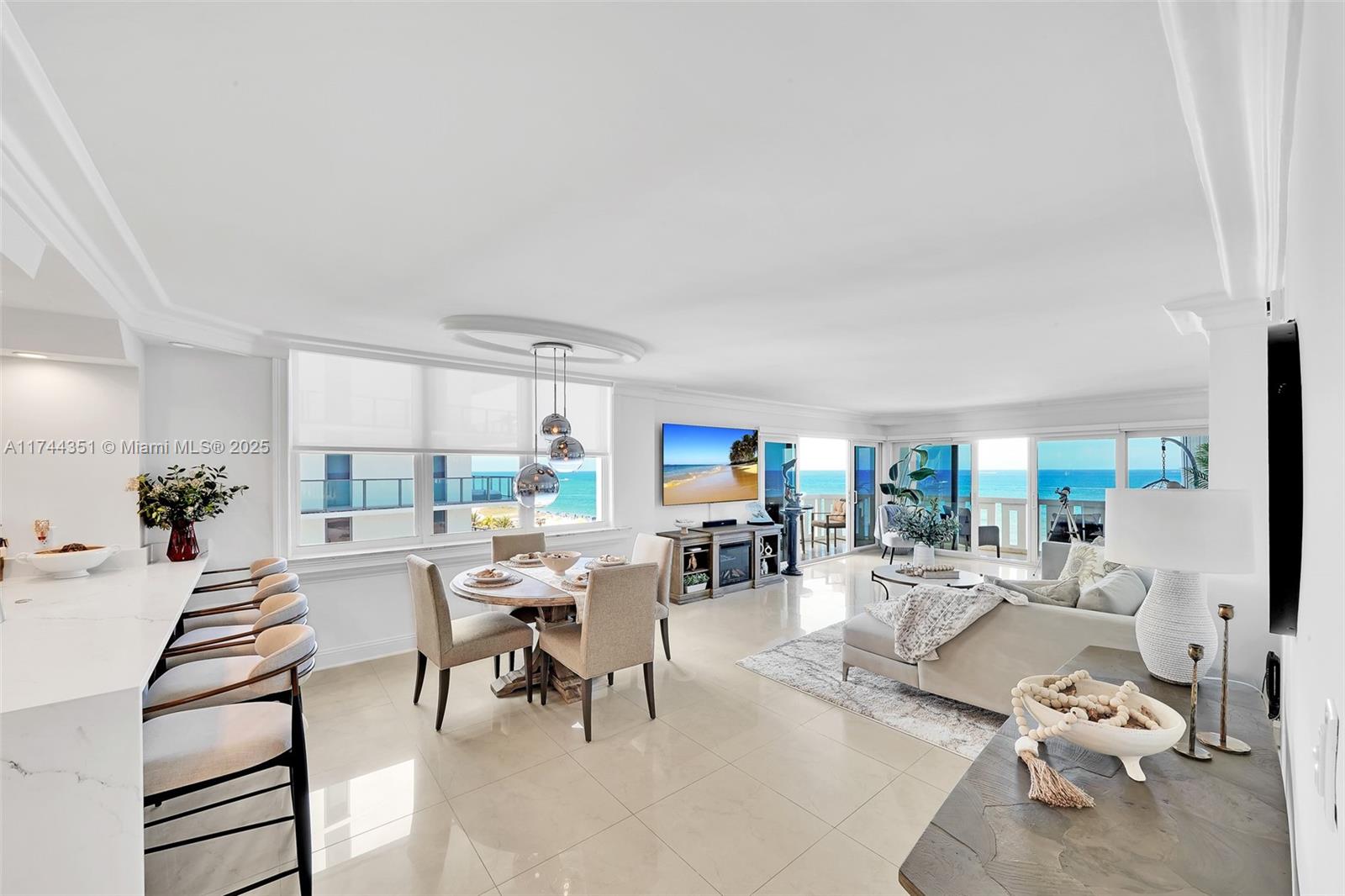 1012 North Ocean Boulevard, Unit 701 Pompano Beach, FL 33062 - Photo 3 of 57 a living room with furniture a large window and a table