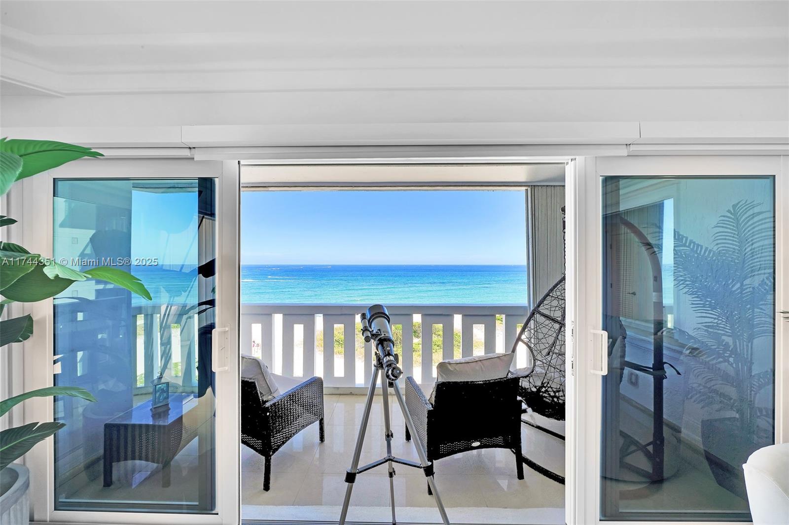 1012 North Ocean Boulevard, Unit 701 Pompano Beach, FL 33062 - Photo 36 of 57 a view of a livingroom with furniture and entryway wooden floor a chandelier