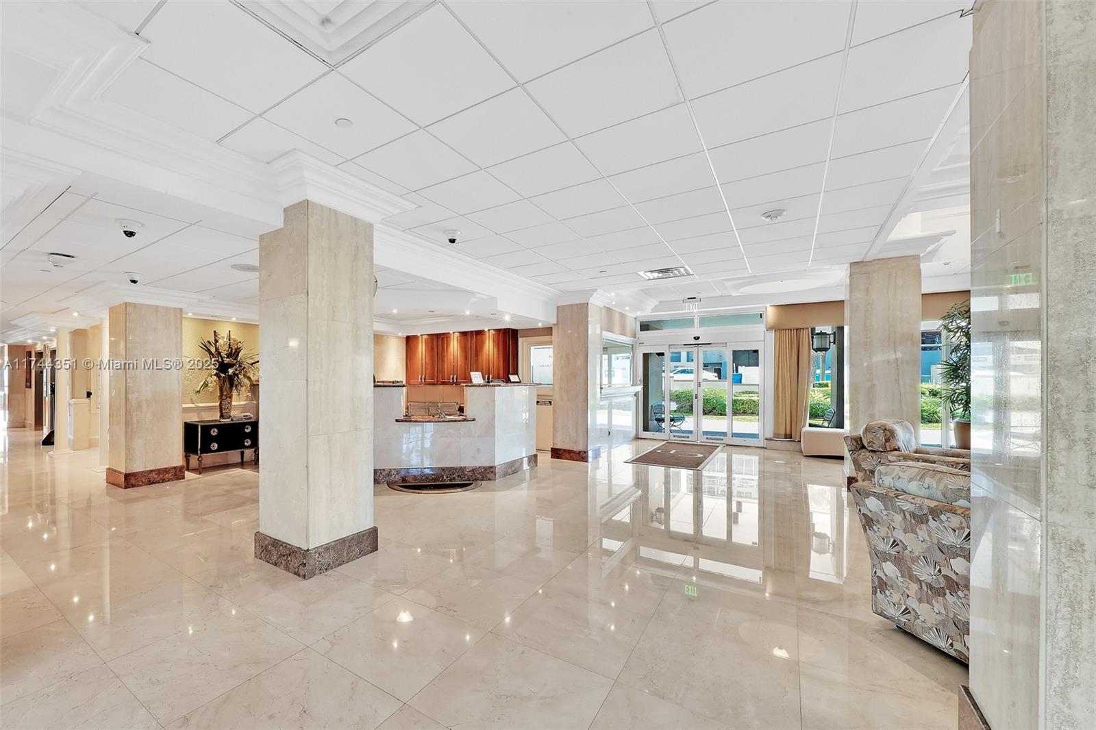 1012 North Ocean Boulevard, Unit 701 Pompano Beach, FL 33062 - Photo 45 of 57 a living room with furniture a large window and wooden floor