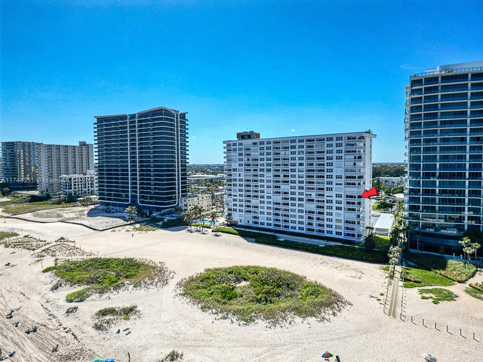 1012 North Ocean Boulevard, Unit 701 Pompano Beach, FL 33062 - Photo 50 of 57 a view of a patio with a table and chairs and wooden fence