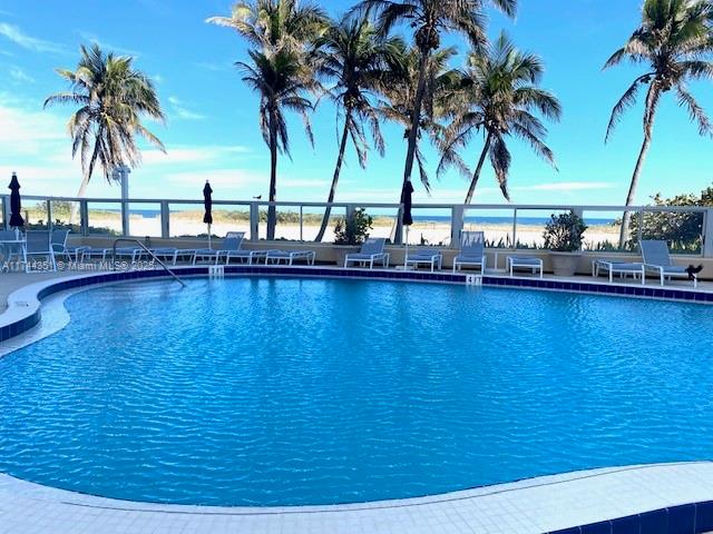 1012 North Ocean Boulevard, Unit 701 Pompano Beach, FL 33062 - Photo 56 of 57 a view of a swimming pool with a table and chairs