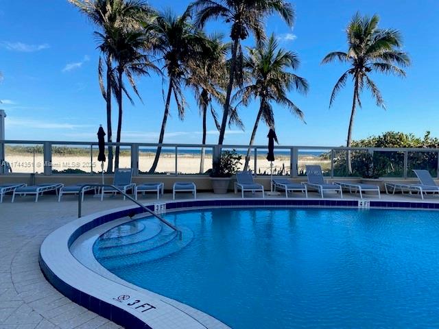 1012 North Ocean Boulevard, Unit 701 Pompano Beach, FL 33062 - Photo 57 of 57 a view of a swimming pool with a table and chairs