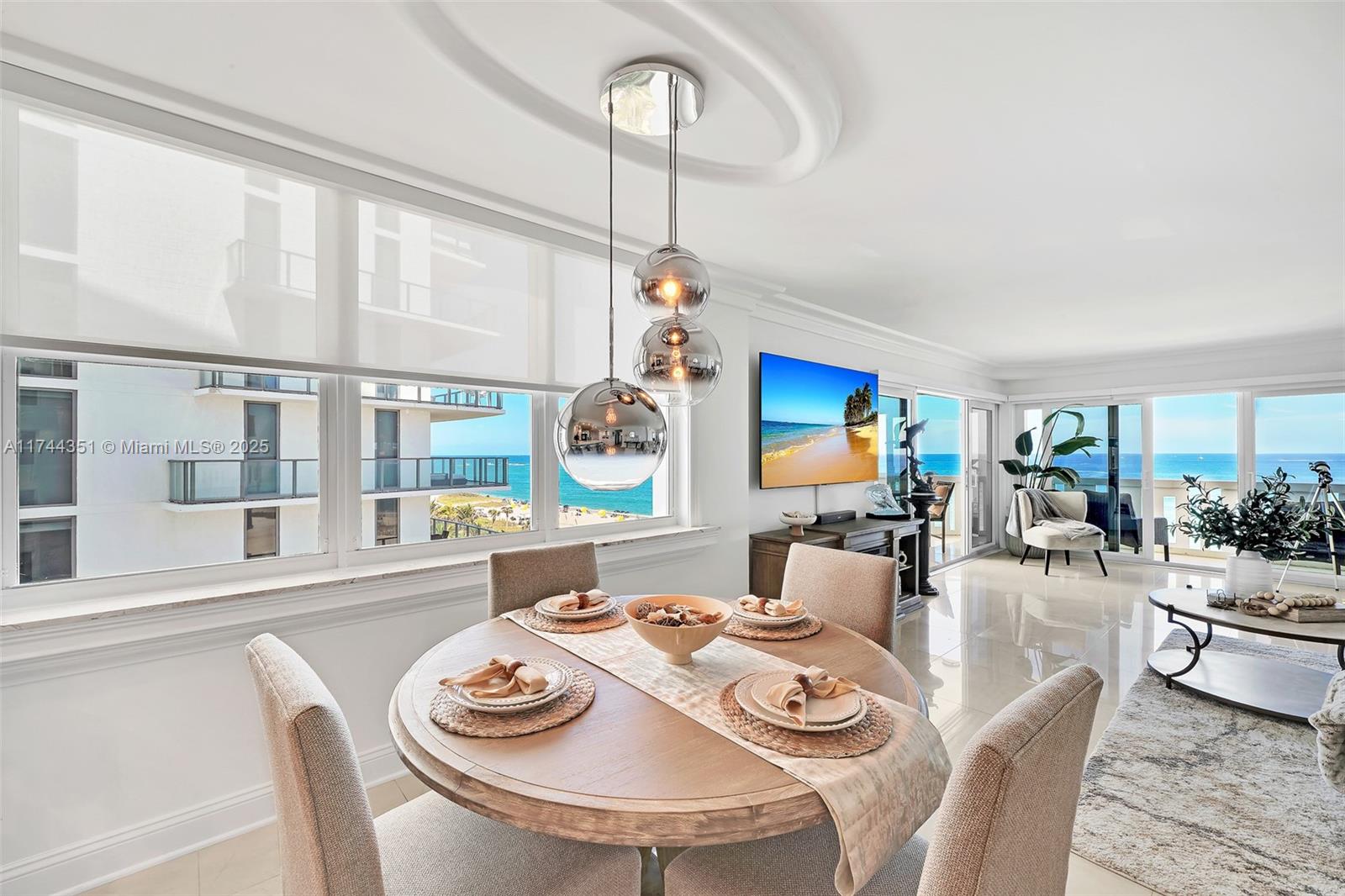 1012 North Ocean Boulevard, Unit 701 Pompano Beach, FL 33062 - Photo 10 of 57 a dining room with furniture a large window and a chandelier