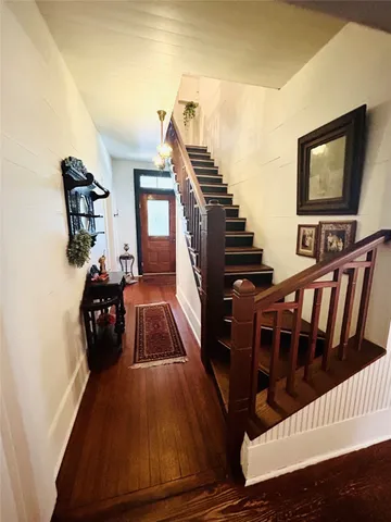 a living room with chairs and a flat screen tv
