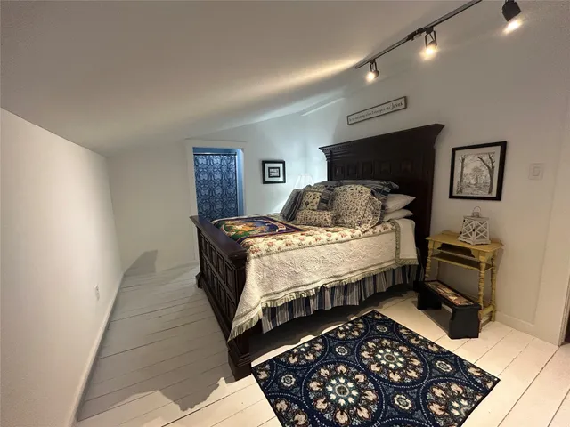 a bedroom with double bed and a window