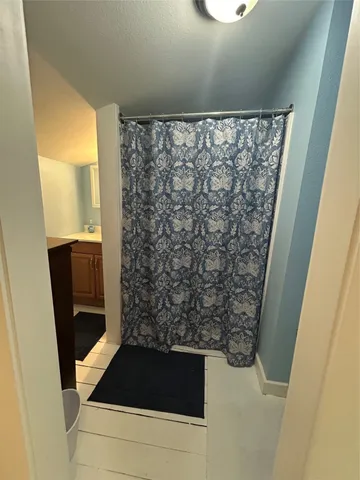 a bathroom with a sink and a shower curtain