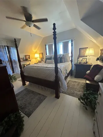 a bedroom with furniture and a window