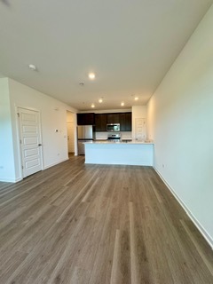 2136 Bodega Road, Unit 2136 Oswego, IL 60543 - Photo 7 of 19 a view of empty room with wooden floor