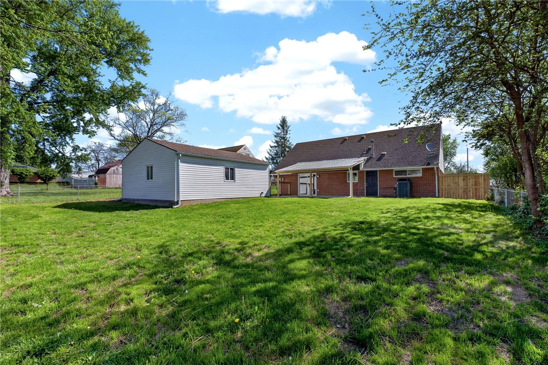 5975 Rosalie Road Dayton, OH 45424 - Photo 39 of 48 This spacious backyard features a separate outbuilding, ample green space, and a charming brick exterior.