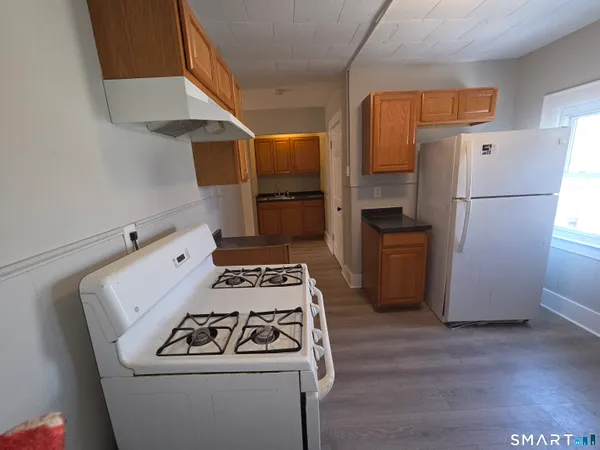 a kitchen with a stove and a refrigerator