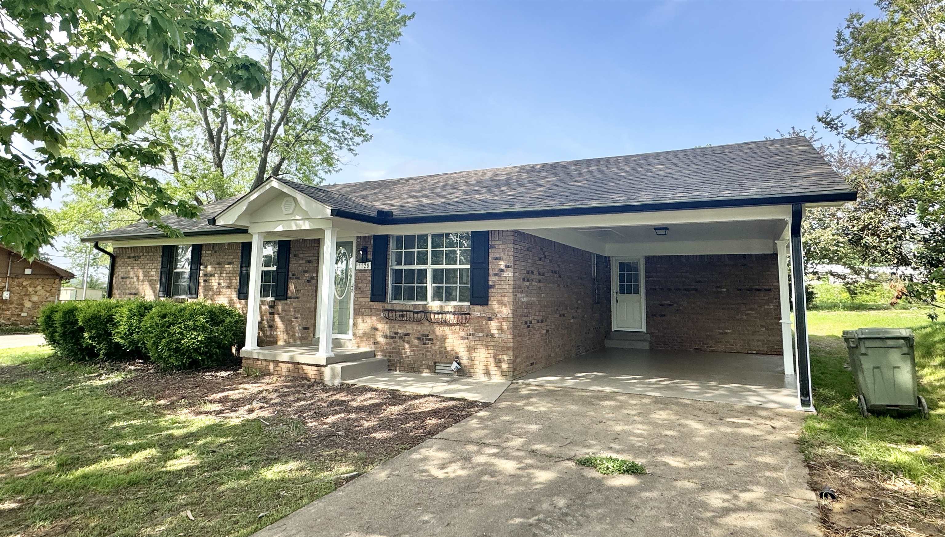 1120 Cedar Grove Extension Ripley, TN 38063 - Photo 1 of 3 Single story home with brick siding, a carport, roof with shingles, and driveway