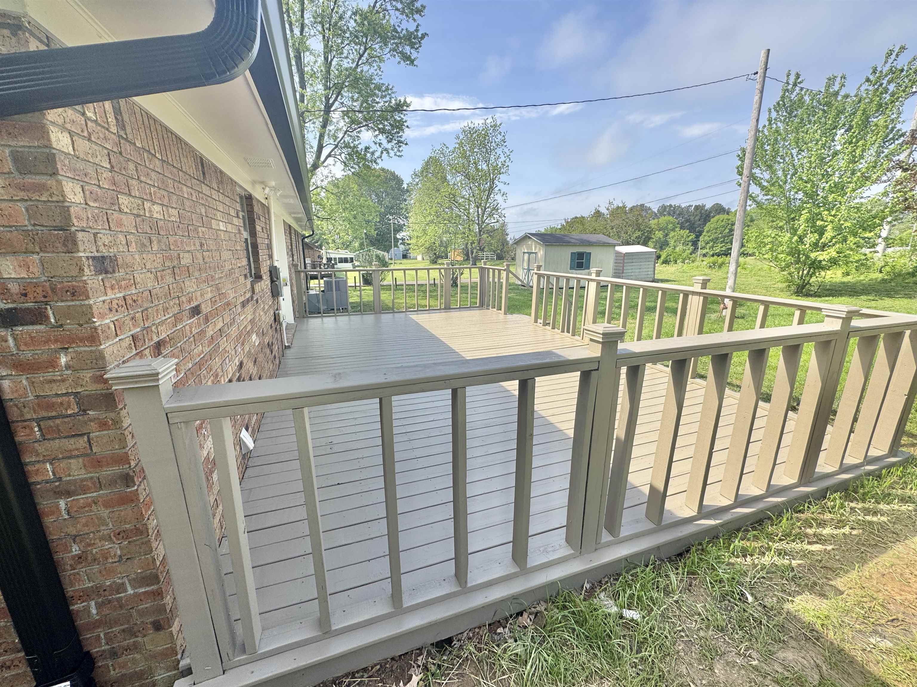 1120 Cedar Grove Extension Ripley, TN 38063 - Photo 3 of 3 Wooden terrace featuring an outdoor structure and a storage shed