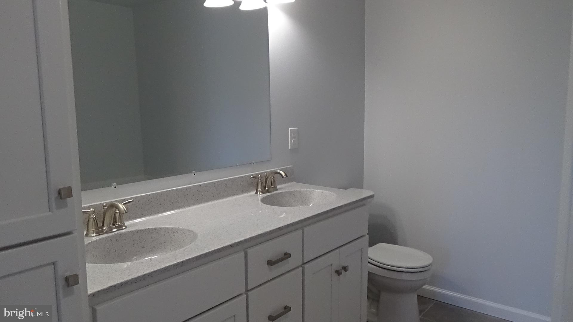 746 Hilltop Road Millerstown, PA 17062 - Photo 16 of 24 a bathroom with a granite countertop sink a toilet and a mirror